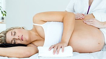 woman lies on her back for prenatal massage